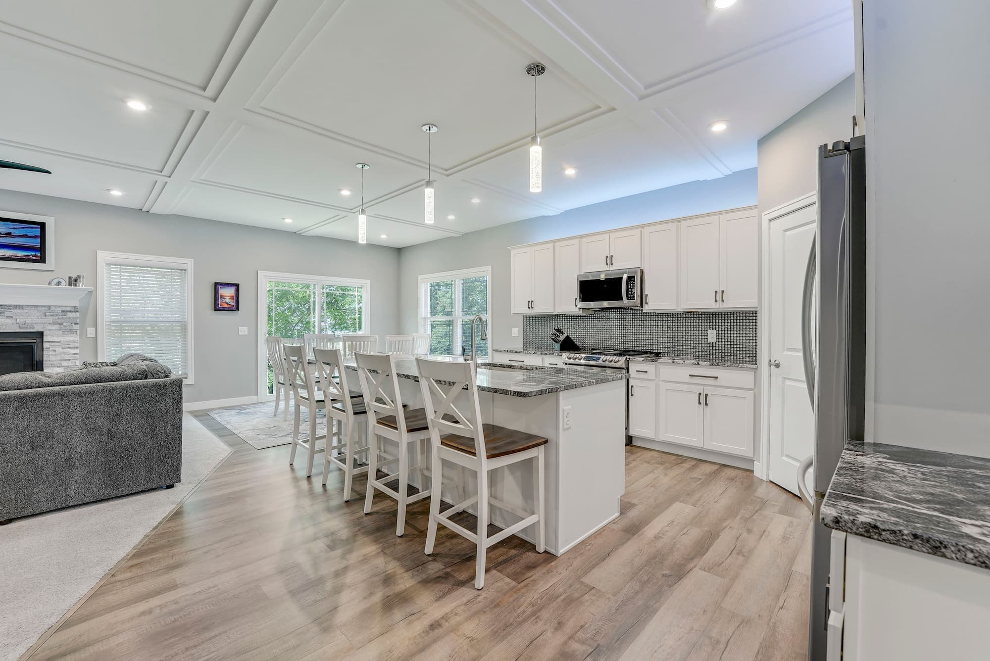Open-concept kitchen with granite island and coffered ceiling at 8342 Brodie Blvd