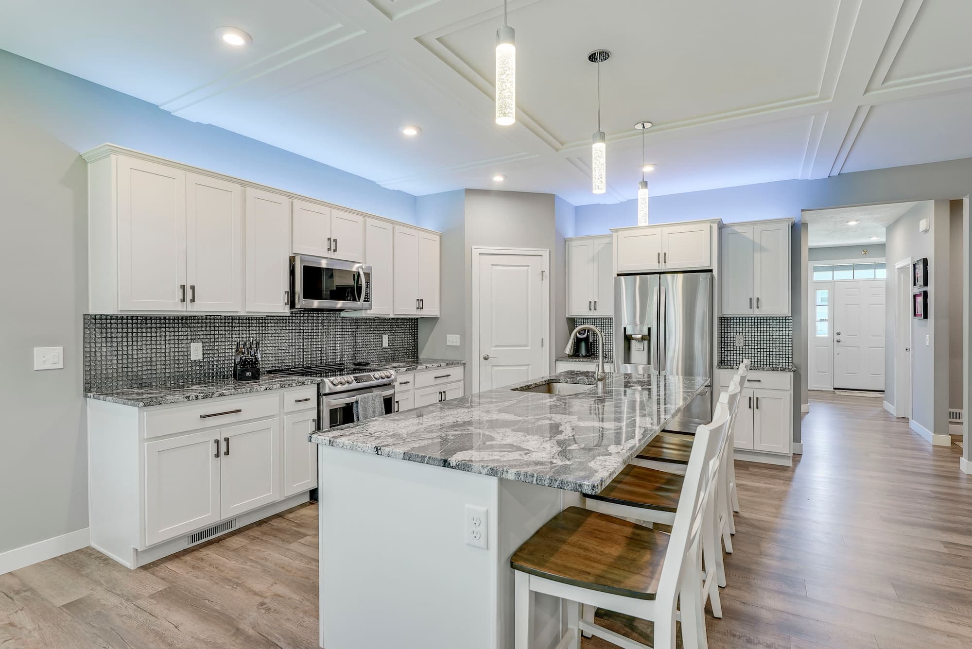 Kitchen with white shaker cabinets, granite island and stainless appliances at 8342 Brodie Blvd