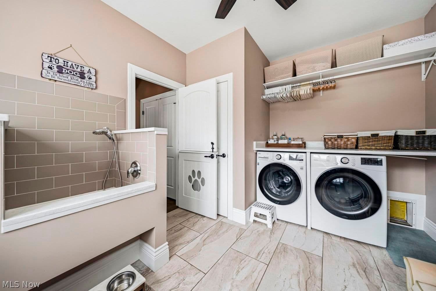 Dog washing station and built-in dog beds in the laundry room